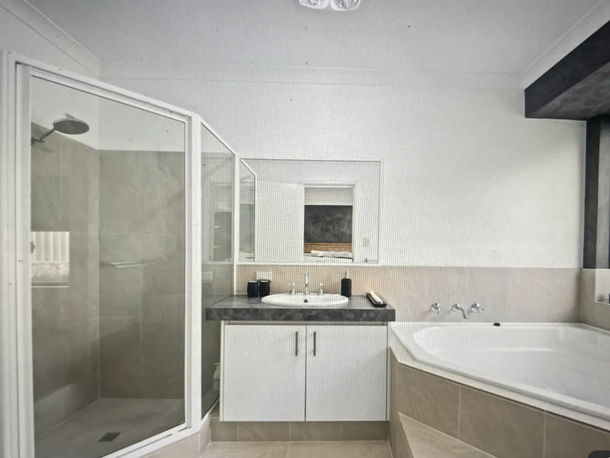 Before: the Hocking ensuite with a corner spa bath, a small framed corner shower and a cupboard vanity