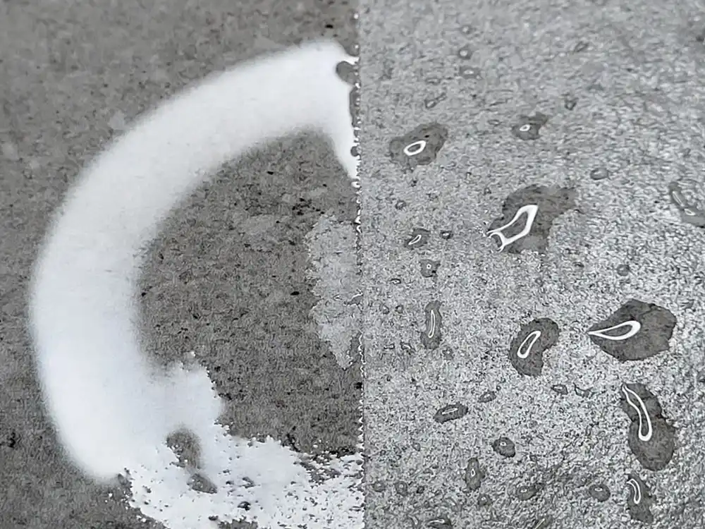 The same wet tile, untreated on the left and coated on the right, with water beading on the coated half