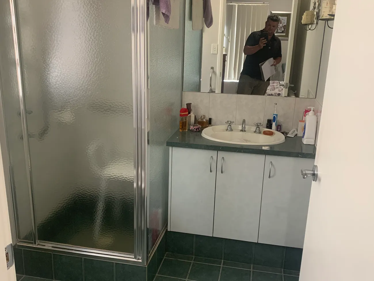 Before: a Perth bathroom ahead of its wet room conversion, with the original enclosed shower and stepped floor